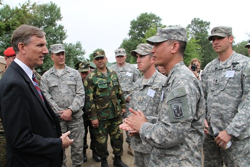 U.S. Air Force Maj. Gen. Steven Cray, the adjutant general of the Vermont National Guard, pins a medal on one of 79 soldiers from the army of Macedonia